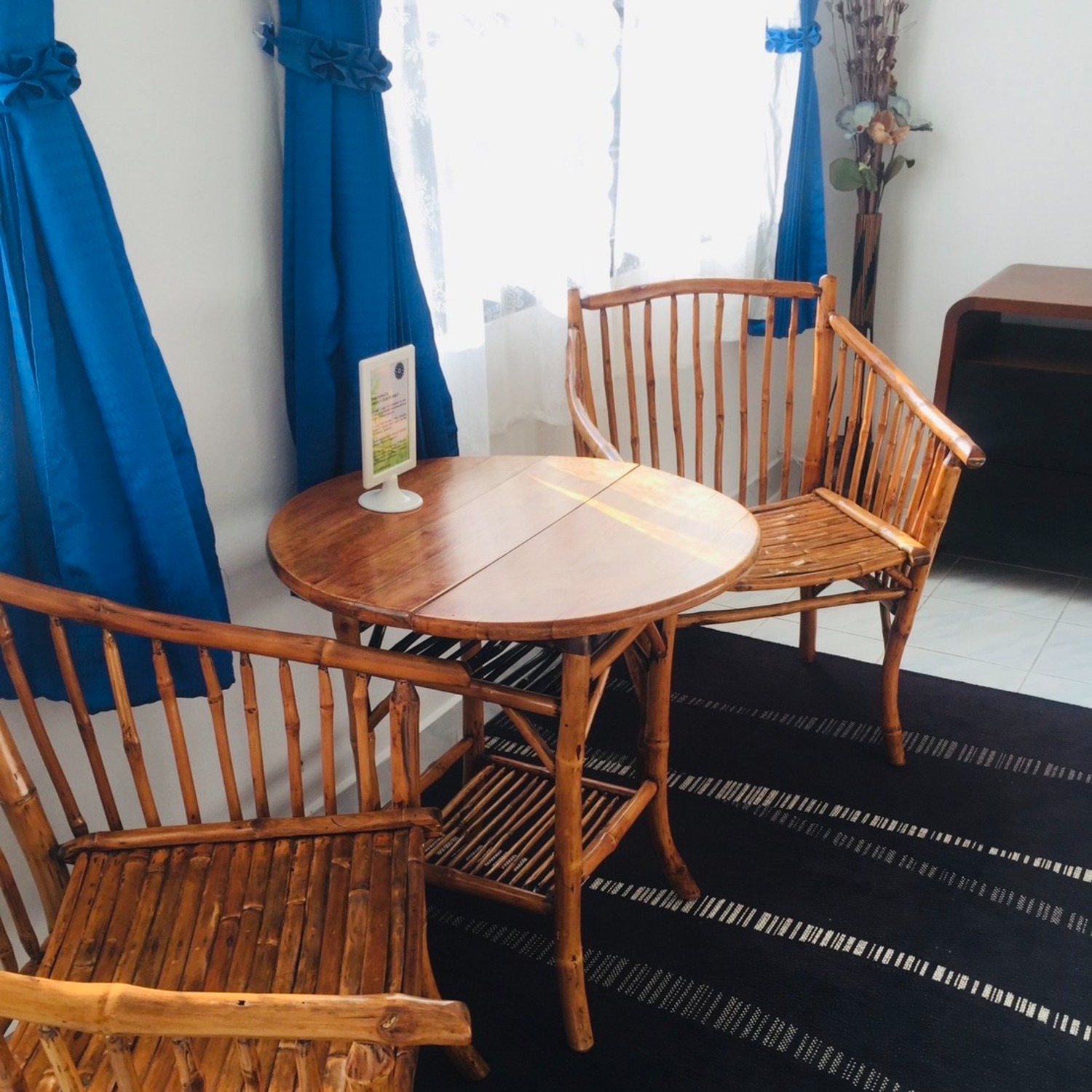 A bamboo table and chairs in the morning-coffee corner of the Deluxe Double Room at Lyndale Lodge